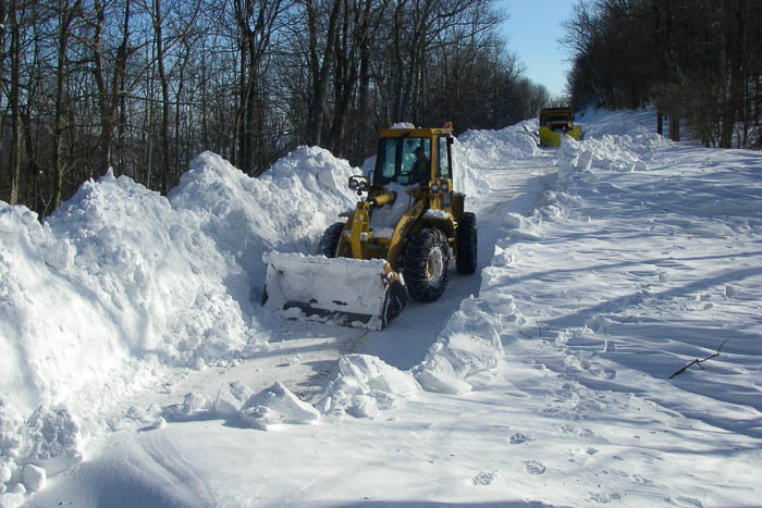 Equipment clearing snow on a roadway